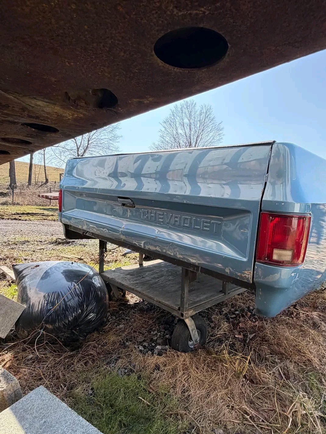 blue long-bed pickup truck bed that appears to be from a 1973–1987 Chevrolet or GMC “square body” truck.