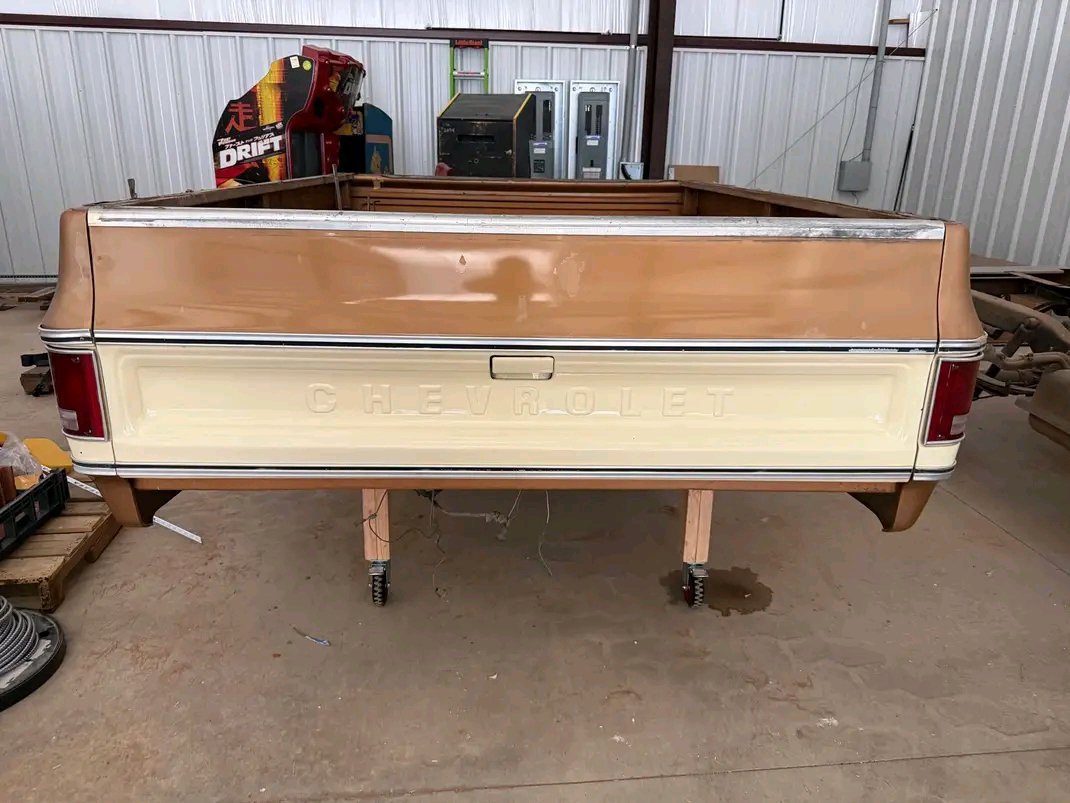 long-bed truck box from a 1973–1987 Chevrolet “squarebody” C/K pickup, featuring a two-tone beige and bronze-brown paint scheme.