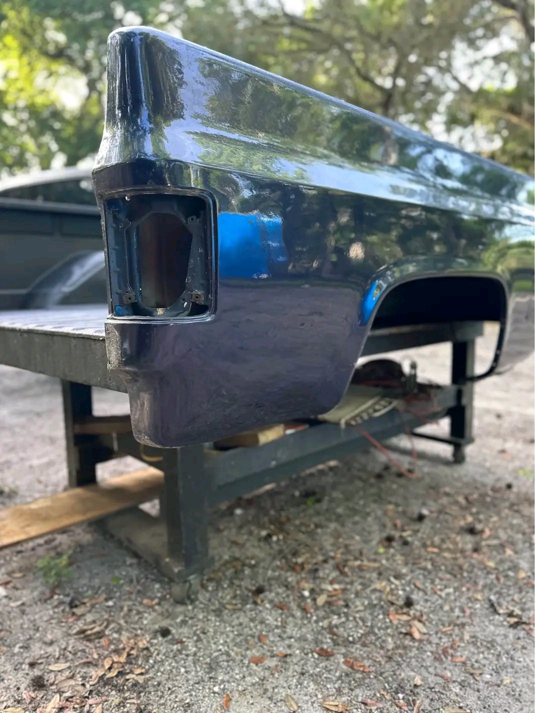 dark blue Fleetside pickup truck bed from a 1973–1987 Chevrolet C/K “square body” series truck.