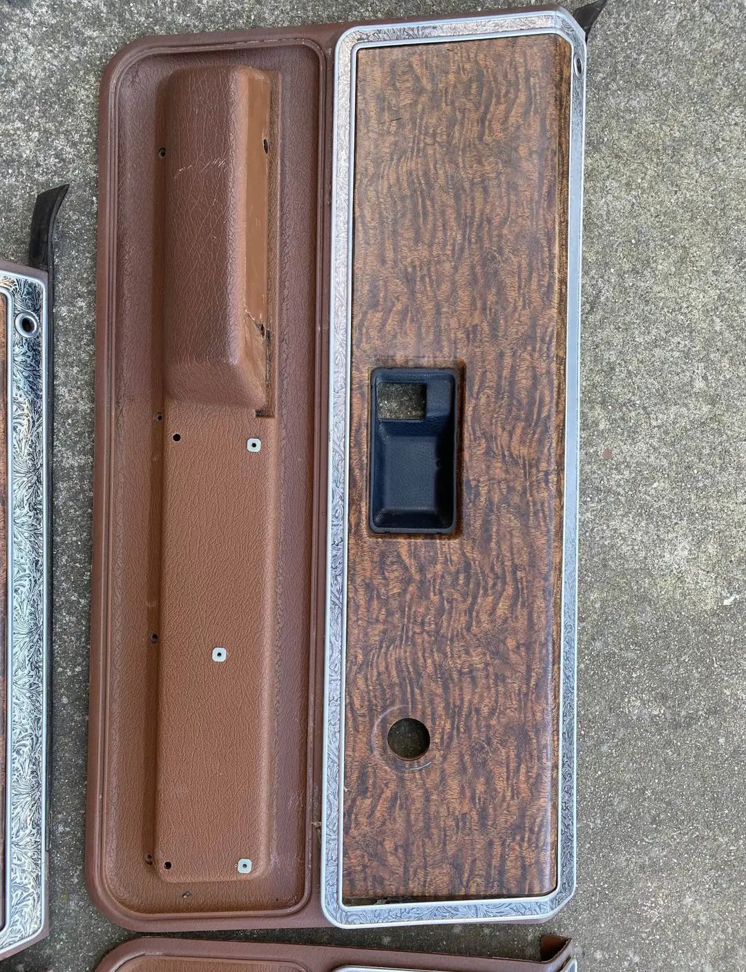 brown interior door panel inserts and armrests with woodgrain trim, which appear to be original parts for 1973–1976 Chevrolet and GMC trucks, Suburbans, and SUVs.