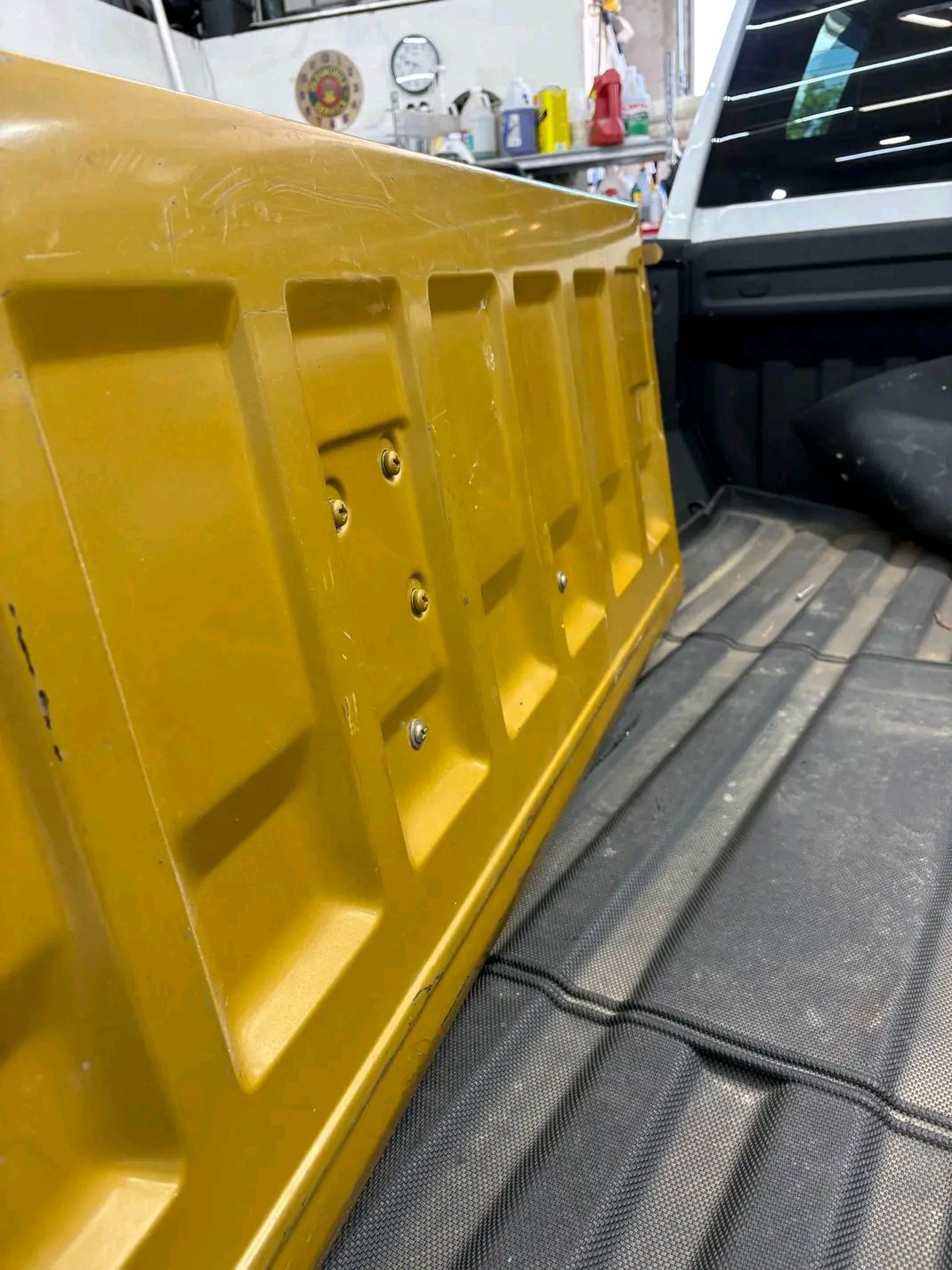 Chevrolet truck tailgate with a distinctive woodgrain panel insert and chrome trim, typical of 1970s “Square Body” generation pickup trucks (1973–1980 era).